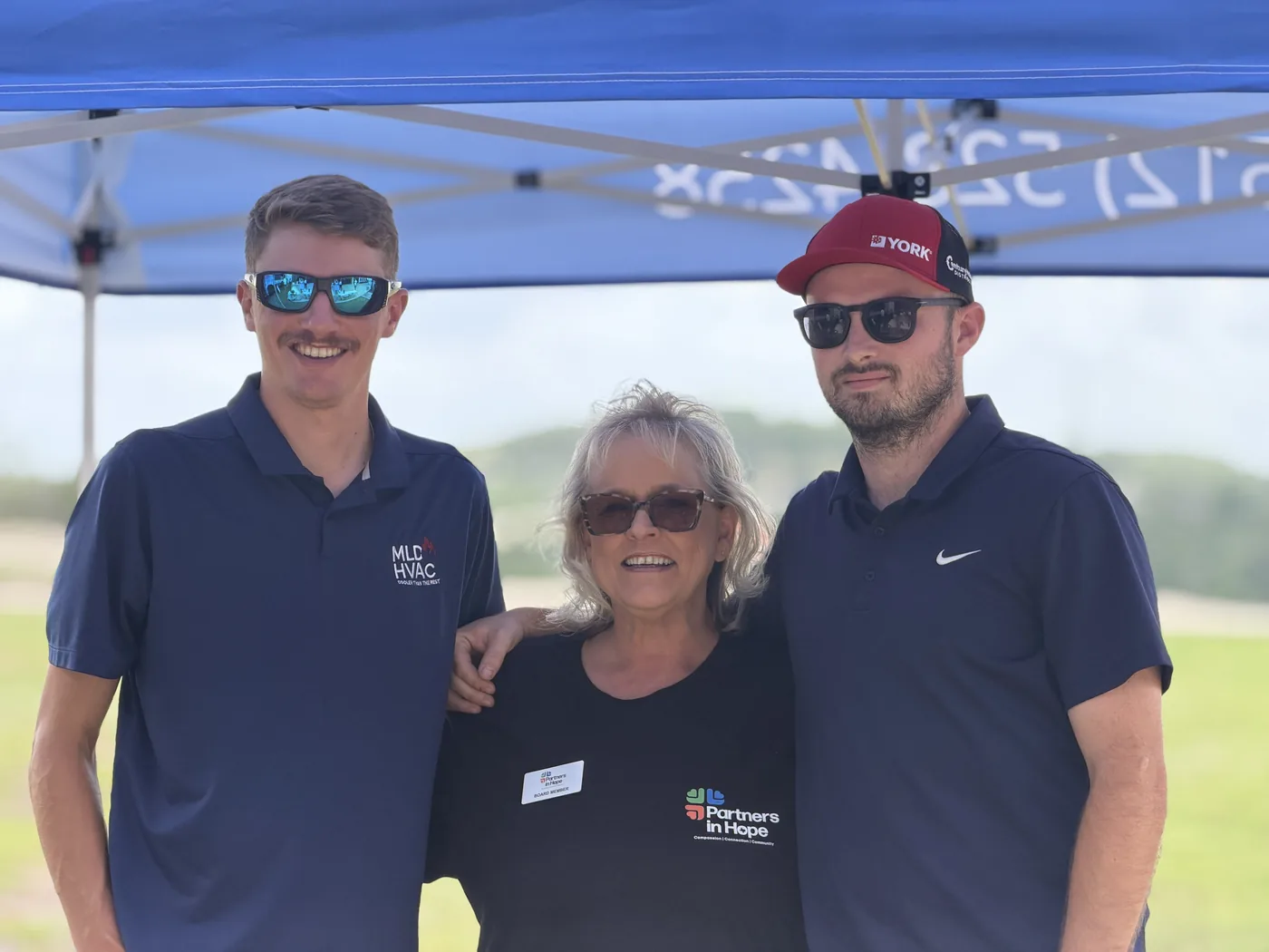 MLD Services team members with a Partners in Hope board member at the MLD-sponsored Partners in Hope summer event.